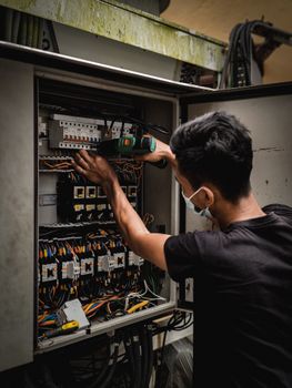 PRC electrician at work on a consumer unit